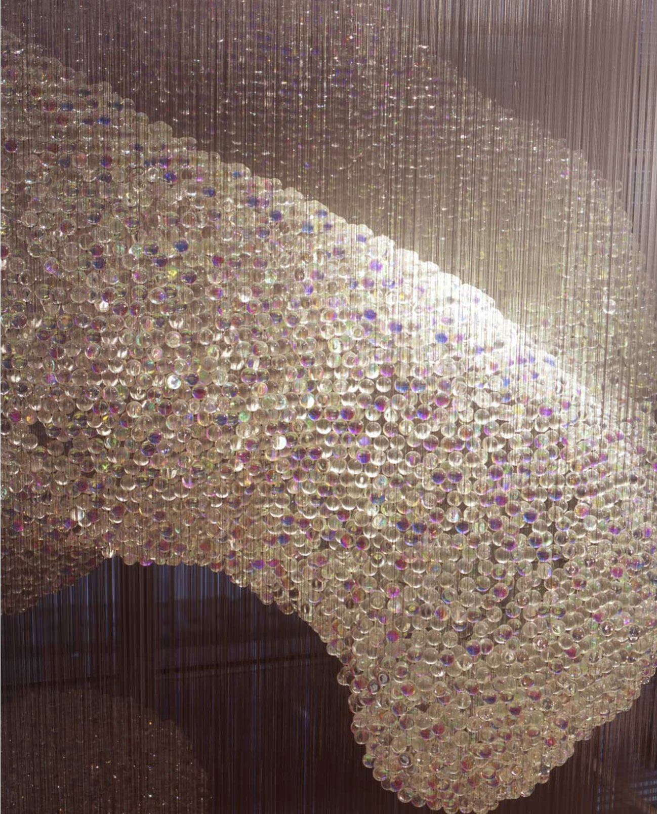 Bleigiessen — glass crystals on transparent lines forming a sculptural cloud of light